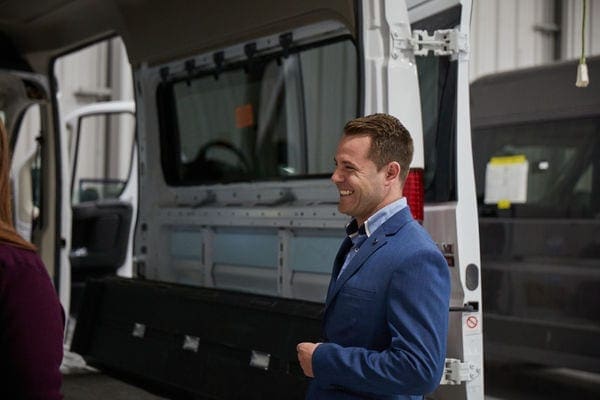 smiling man doing a demo with accessible van