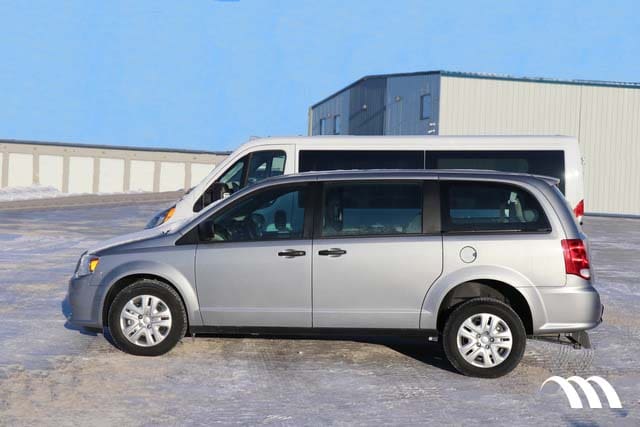 Dodge Grand Caravan and MoveMobility P3 wheelchair van parked side by side showing size similarities