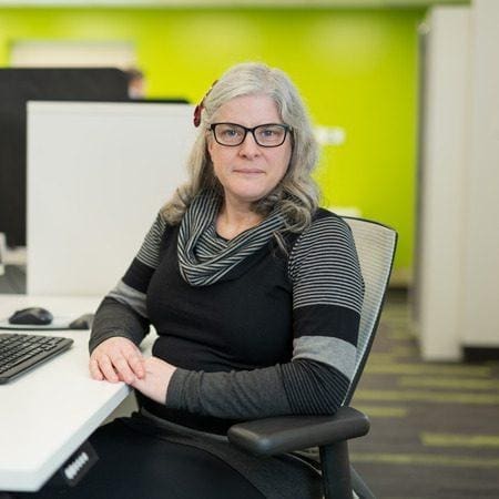 Lady smiling for photo in an office