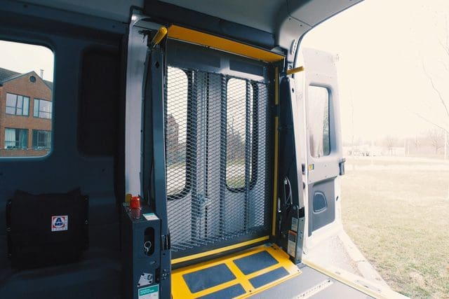 BraunAbility wheelchair lift mounted in rear curbside of Ford Transit T6 van