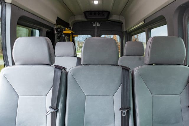 Grey transit seats with integrated seat belts