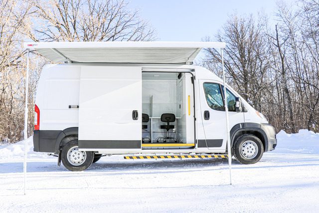 The Mobile Mitigation Van (MM Model) awning tent setup outside during winter.