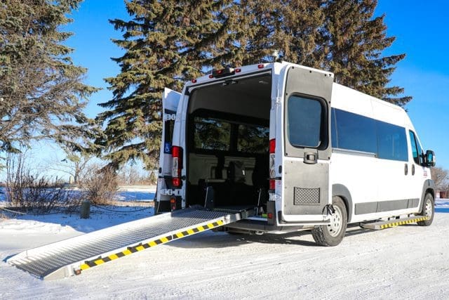 Rear view of rear entry Ram Promaster wheelchair van with manual ramp.