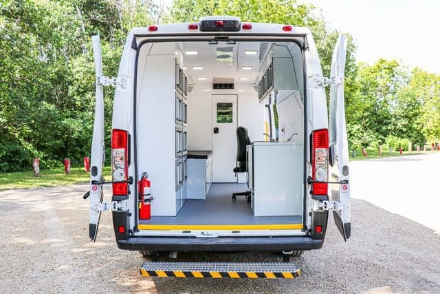 Mobile Medical OBGYN Clinic Van looking inside bright, clean office space from the rear with doors open