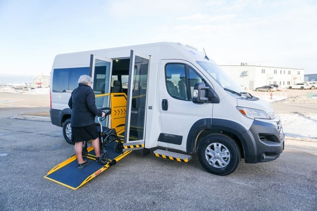 Person using a walker on a P4 side ramp van from MoveMobility