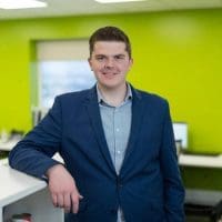 Man smiling for photo in a office