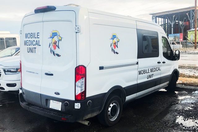 Blood Tribe Department of Health Mobile Medical Unit program van parked in community centre parking lot